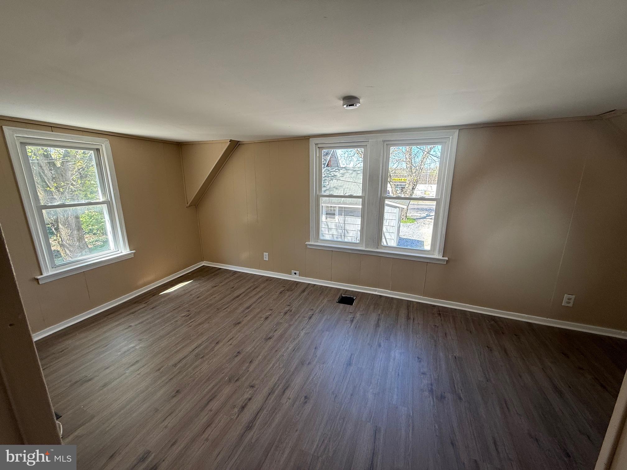1453 South Main Road, Unit 5 Vineland, NJ 08360 - Photo 5 of 7 a view of an empty room with wooden floor and a window
