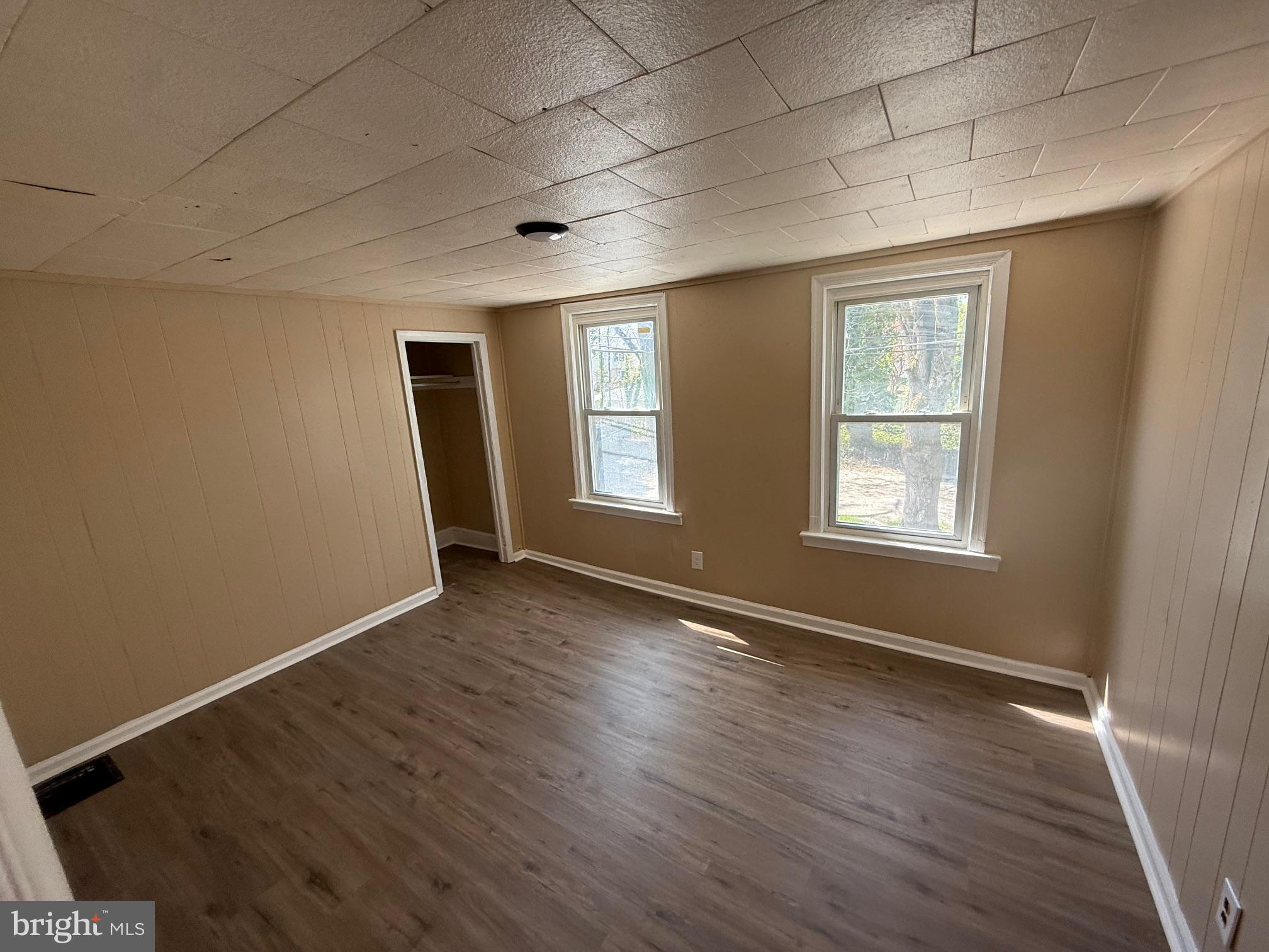 1453 South Main Road, Unit 5 Vineland, NJ 08360 - Photo 6 of 7 an empty room with wooden floor and windows