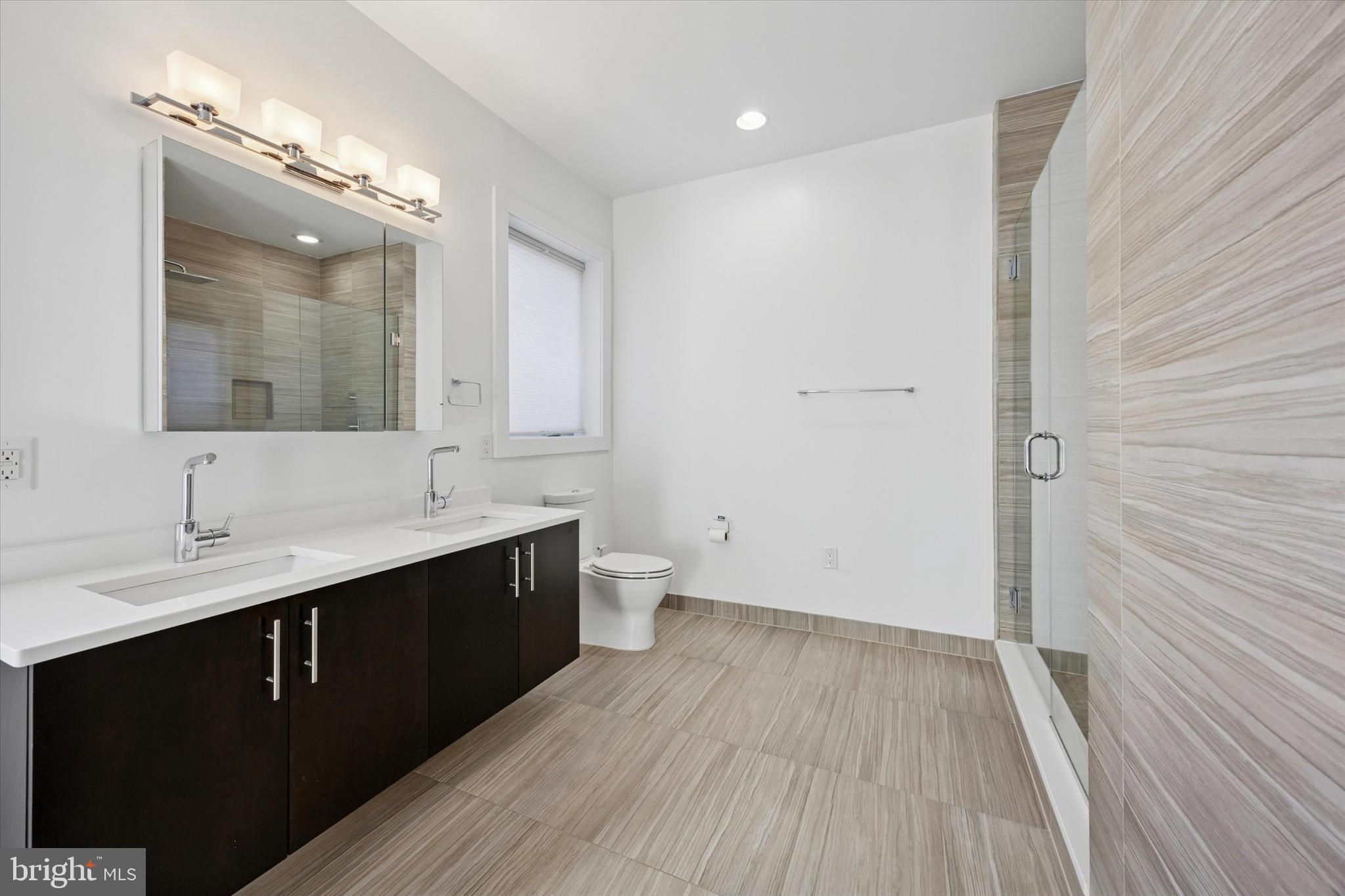 152 North Front Street Philadelphia, PA 19106 - Photo 12 of 25 a spacious bathroom with a double vanity sink and mirror