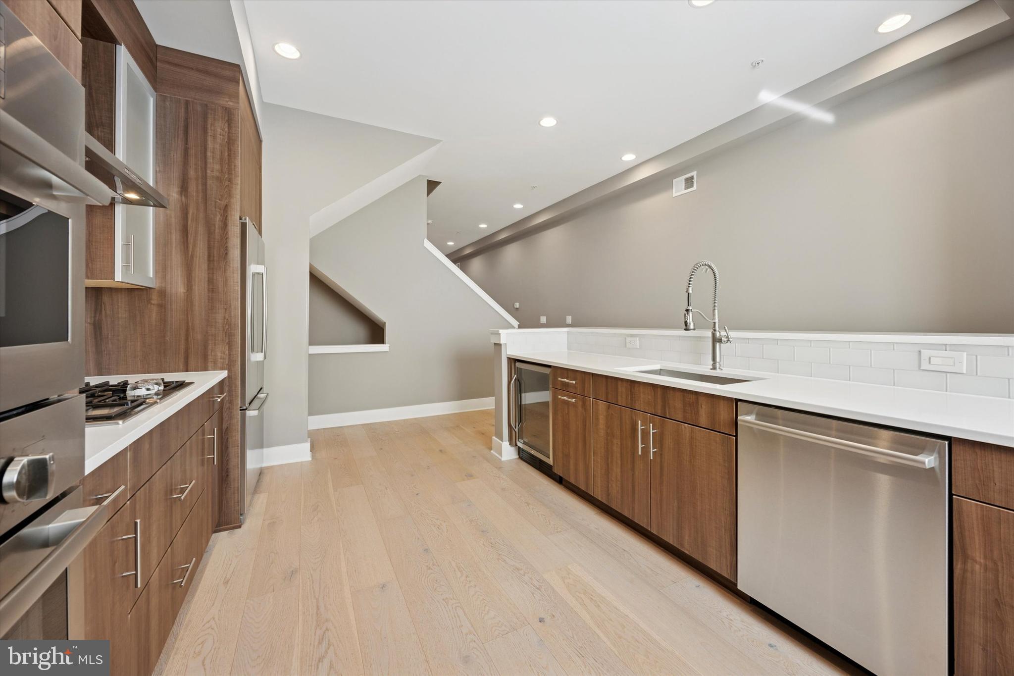 152 North Front Street Philadelphia, PA 19106 - Photo 5 of 25 a kitchen with stainless steel appliances granite countertop a sink and a stove top oven