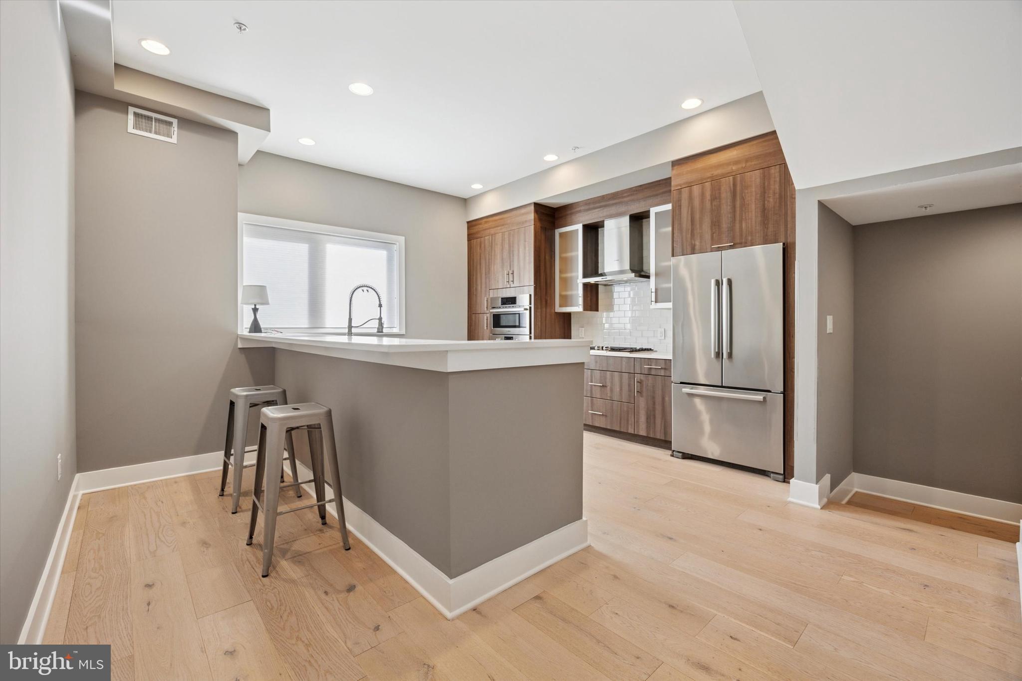 152 North Front Street Philadelphia, PA 19106 - Photo 6 of 25 a kitchen with stainless steel appliances granite countertop a refrigerator and a stove top oven