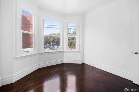a view of room with window and hardwood floor