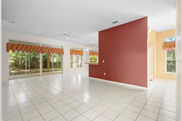 a view of a kitchen with furniture and an empty room