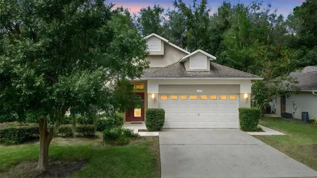 a front view of a house with a yard and garage