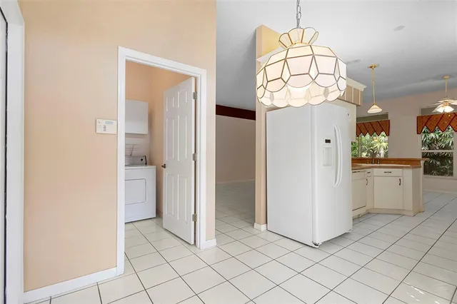 a spacious bedroom with a bed and a flat screen tv