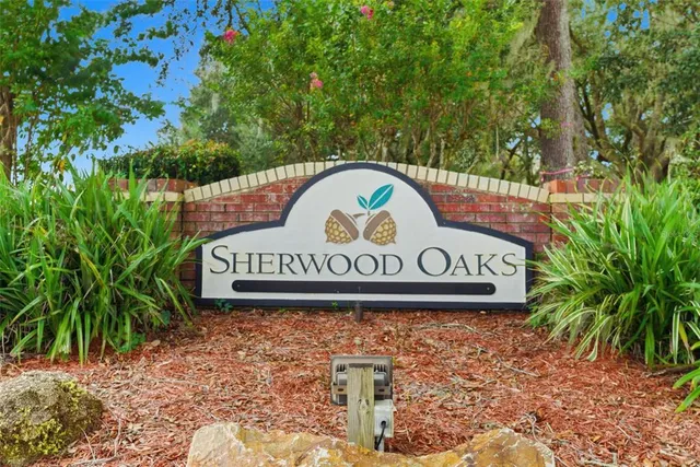 a street sign that is sitting on a brick wall