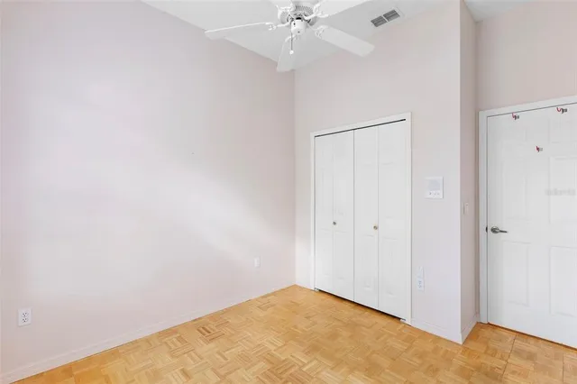 a bathroom with a granite countertop sink a large mirror a toilet and a window