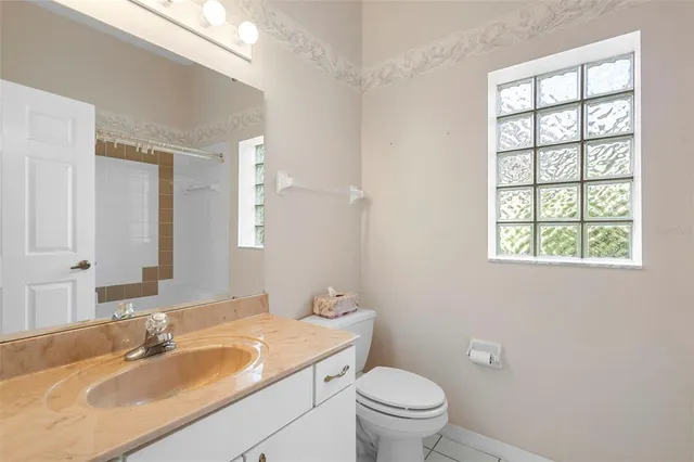a view of a hallway with white walls and chandelier