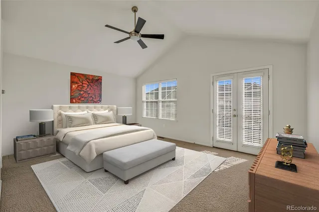 a bedroom with a bed and a ceiling fan