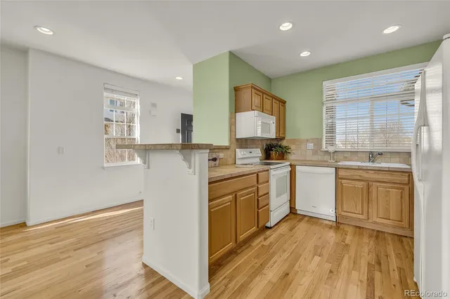 a kitchen with a sink a window a counter top space stainless steel appliances and cabinets