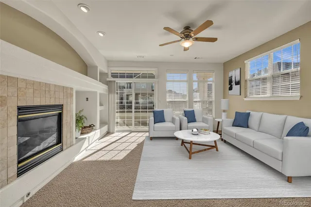 a living room with furniture and a fireplace