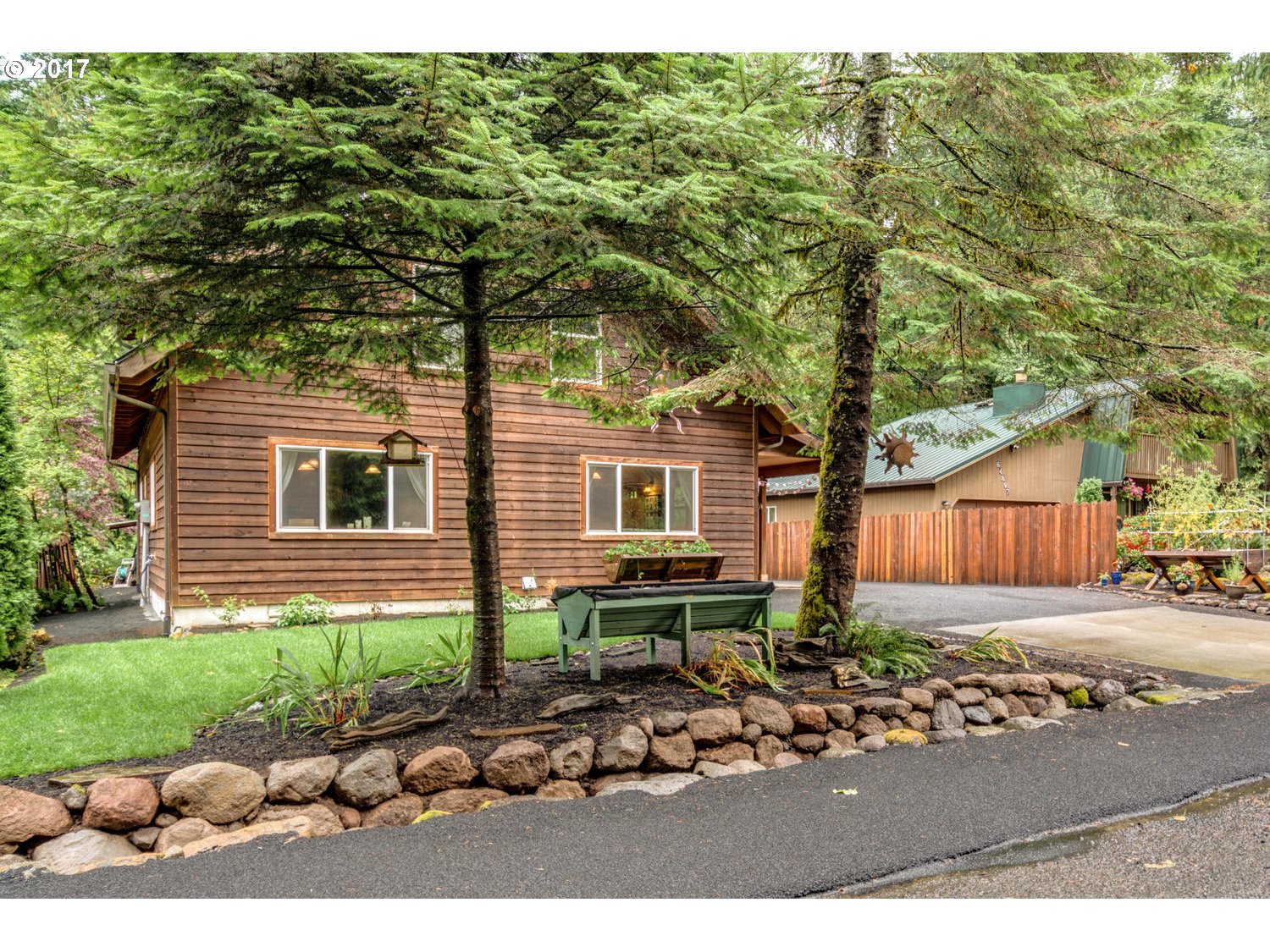 64877 East Pine Tree Way Rhododendron, OR 97049 - Photo 2 of 29 a front view of a house with garden