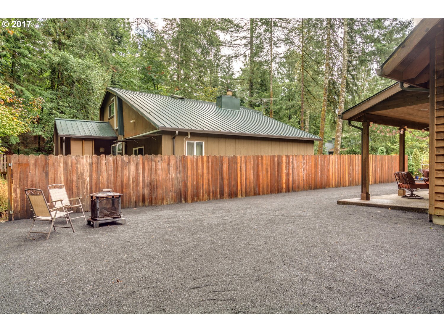 64877 East Pine Tree Way Rhododendron, OR 97049 - Photo 28 of 29 a backyard of a house with table and chairs