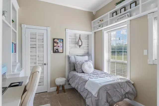 a bedroom with a bed and a window