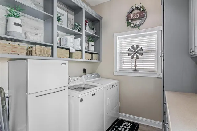 a kitchen with a refrigerator and cabinets