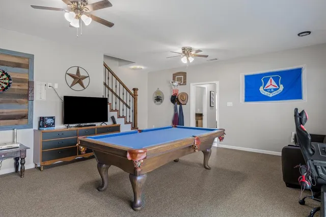 a living room with furniture a table and a chandelier