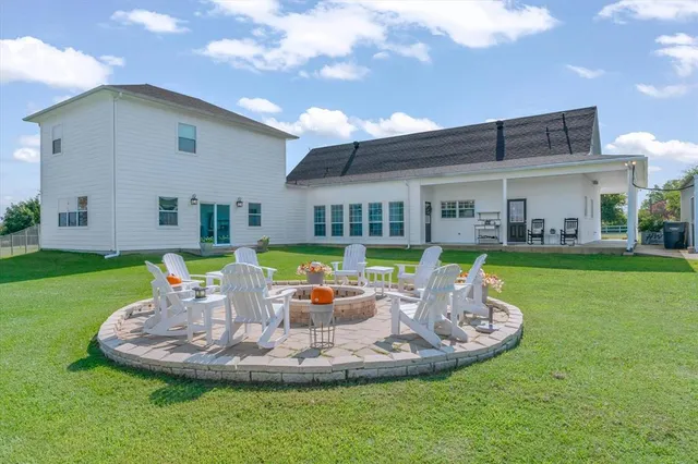 a view of a lake with a yard table and chairs