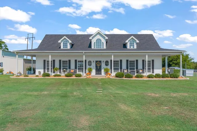 a living room with furniture kitchen view and a flat screen tv