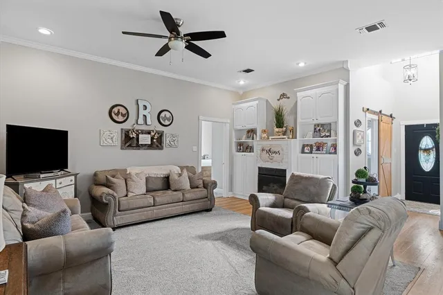 a kitchen with stainless steel appliances a dining table and chairs