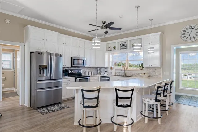 a kitchen with a sink stove and cabinets