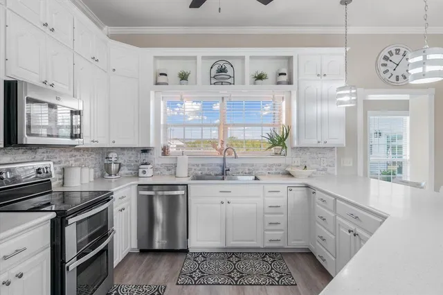 a view of a dining room with furniture wooden floor and a chandelier