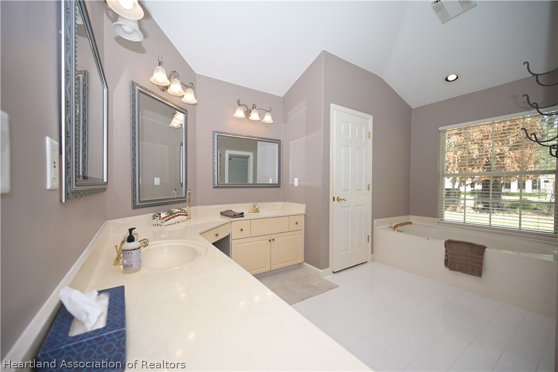 2737 Cheyenne Road Sebring, FL 33875 - Photo 20 of 50 a spacious bathroom with a granite countertop sink mirror and a bathtub