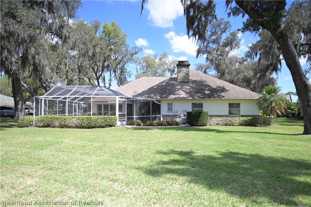 2737 Cheyenne Road Sebring, FL 33875 - Photo 43 of 50 a front view of a house with a garden