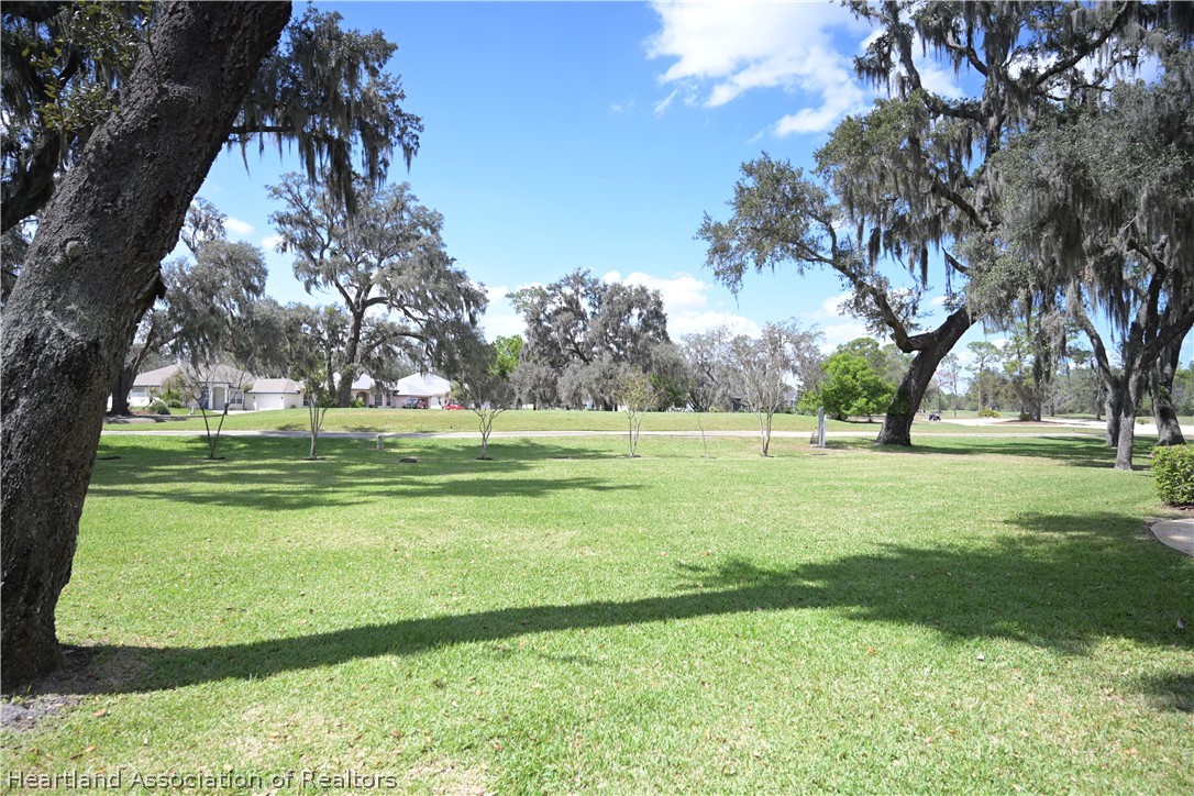 2737 Cheyenne Road Sebring, FL 33875 - Photo 44 of 50 a view of grassy field with benches and trees all around