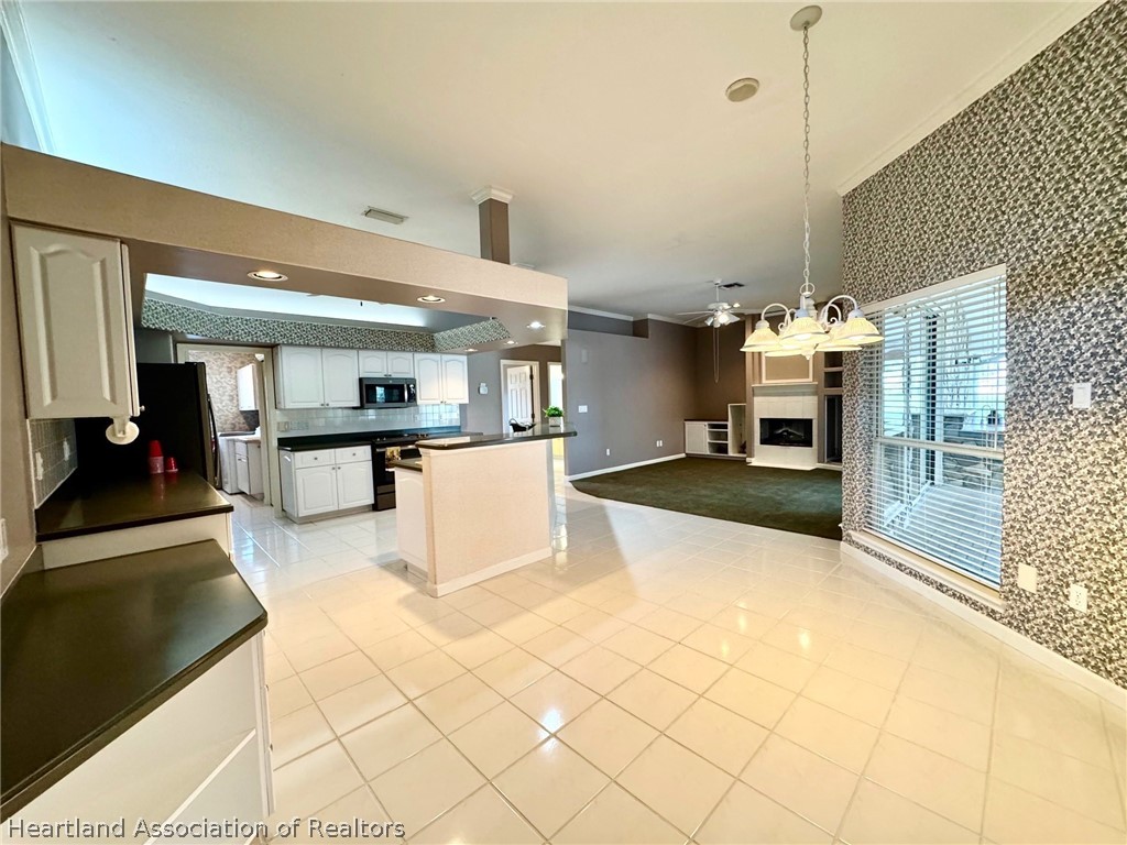 2737 Cheyenne Road Sebring, FL 33875 - Photo 7 of 50 a view of kitchen with furniture and refrigerator