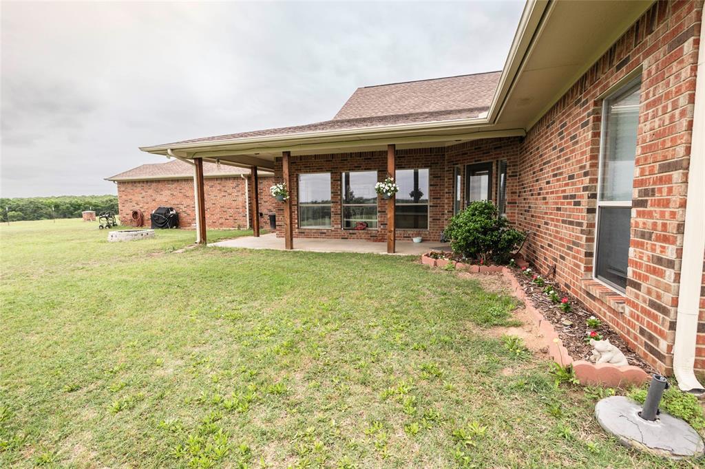 2168 Fruitland Road Sunset, TX 76270 - Photo 11 of 40 a view of a house with a yard and sitting area
