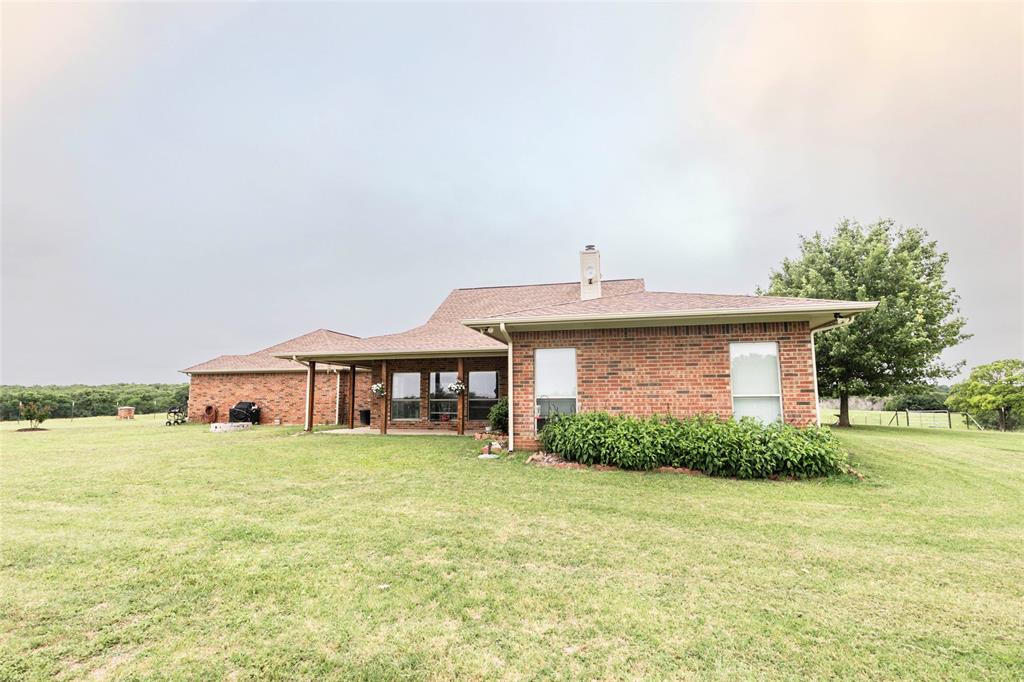 2168 Fruitland Road Sunset, TX 76270 - Photo 12 of 40 a front view of a house with a yard and garage