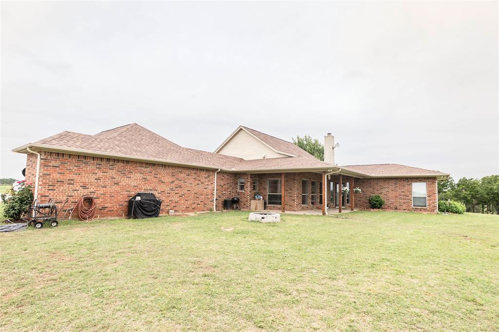 2168 Fruitland Road Sunset, TX 76270 - Photo 13 of 40 a view of a house with a yard and sitting area