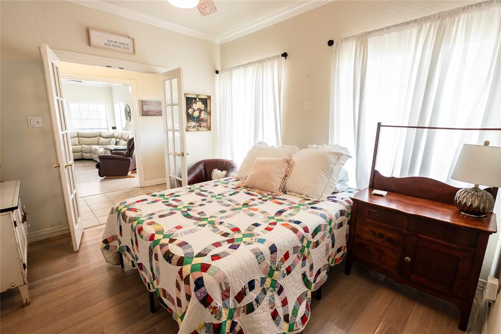 2168 Fruitland Road Sunset, TX 76270 - Photo 14 of 40 a bedroom with a bed and wooden floor