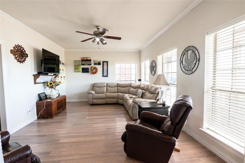 2168 Fruitland Road Sunset, TX 76270 - Photo 17 of 40 a living room with furniture a flat screen tv and a window