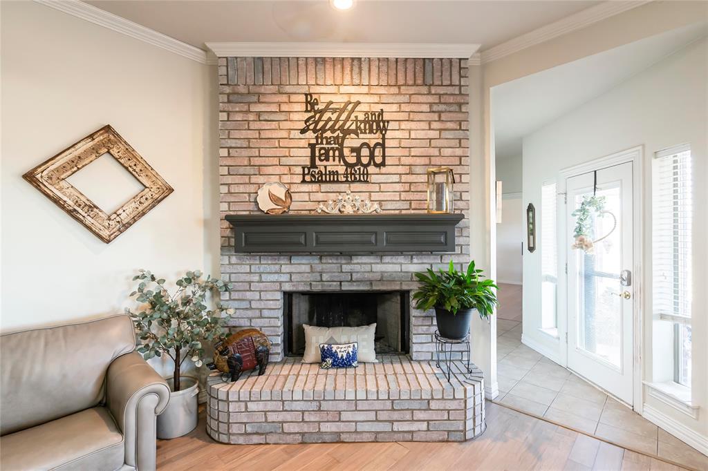 2168 Fruitland Road Sunset, TX 76270 - Photo 23 of 40 a view of a livingroom with a fireplace wooden floor and windows