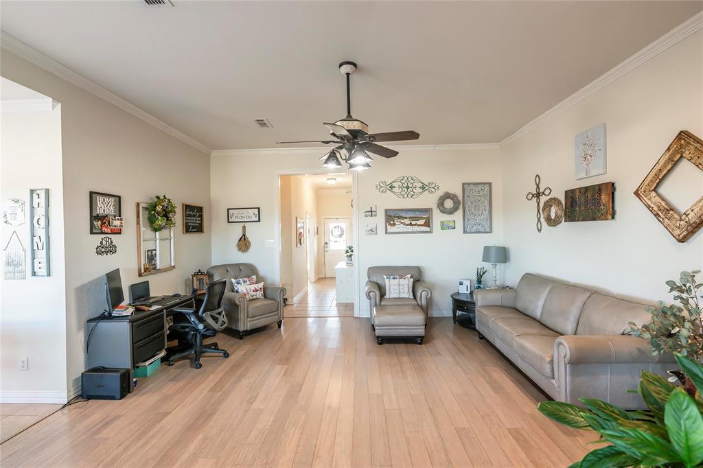 2168 Fruitland Road Sunset, TX 76270 - Photo 25 of 40 a living room with furniture and a wooden floor
