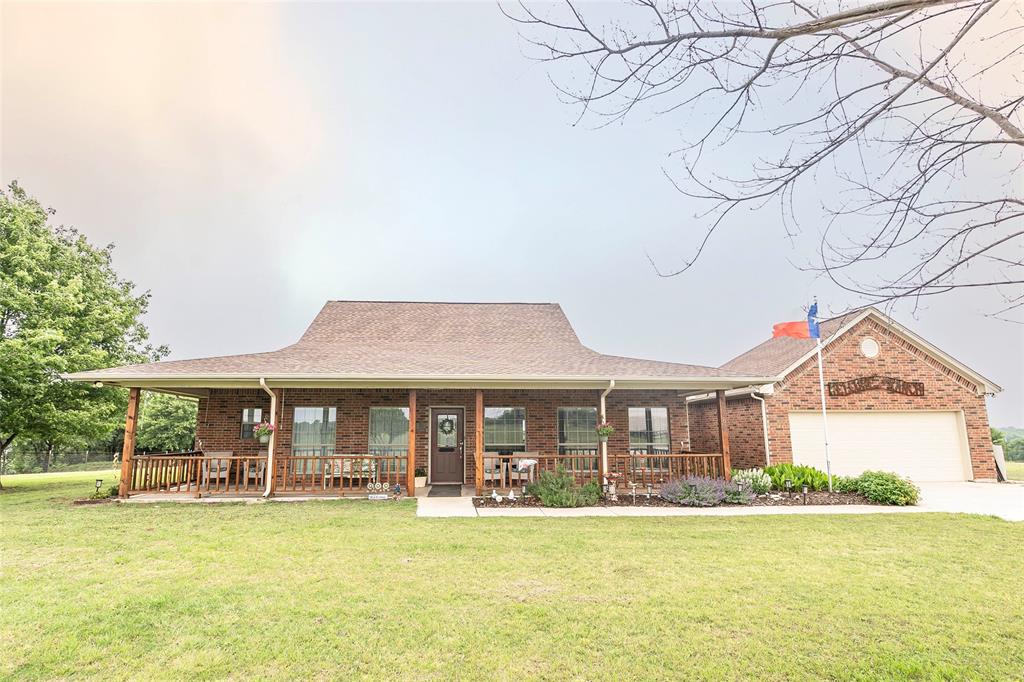 2168 Fruitland Road Sunset, TX 76270 - Photo 4 of 40 a front view of a house with swimming pool having outdoor seating