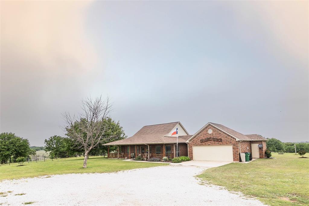 2168 Fruitland Road Sunset, TX 76270 - Photo 5 of 40 a front view of a house with a yard
