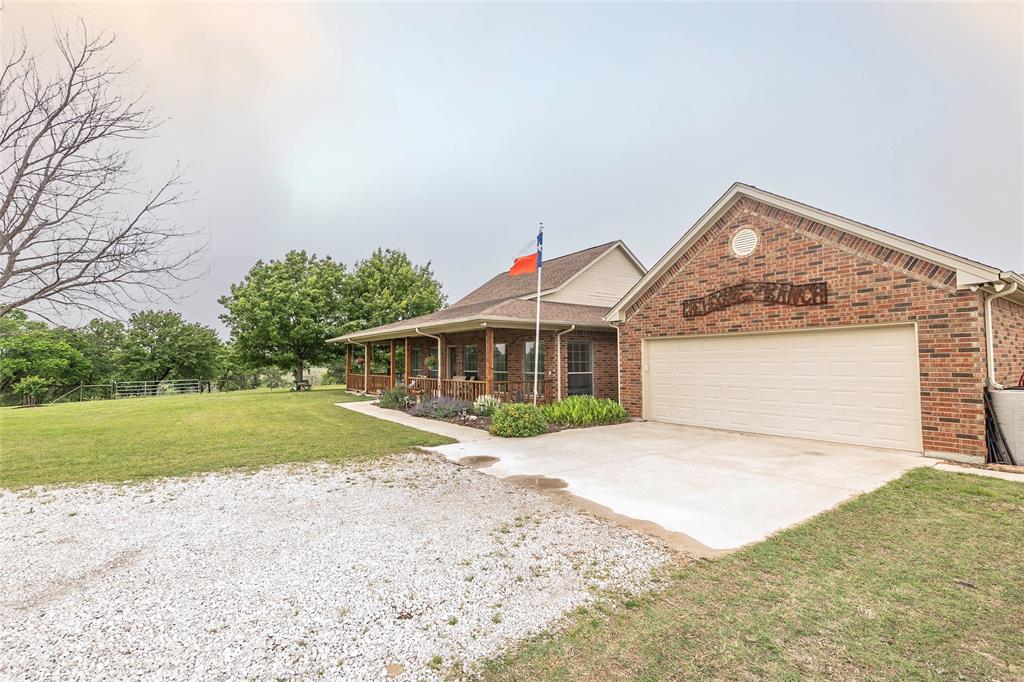 2168 Fruitland Road Sunset, TX 76270 - Photo 7 of 40 a front view of a house with a yard and garage