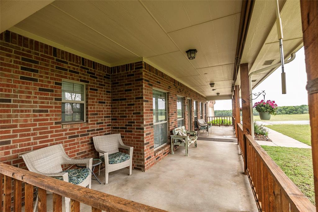 2168 Fruitland Road Sunset, TX 76270 - Photo 8 of 40 a balcony with chairs and table in a balcony