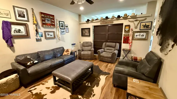 a room with furniture a flat screen tv and gym equipment