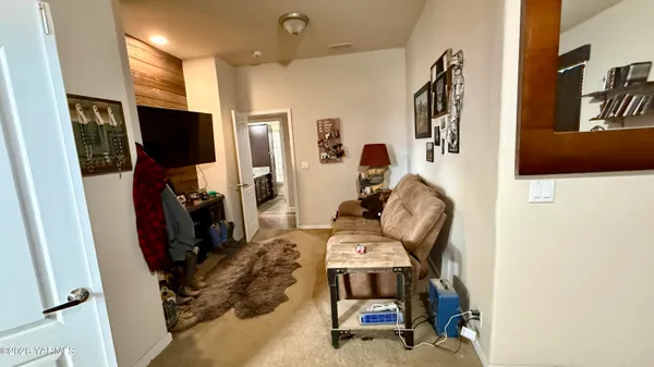 a view of hallway with furniture and a rug