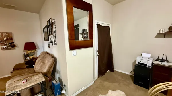 a bedroom with a chair and a chandelier