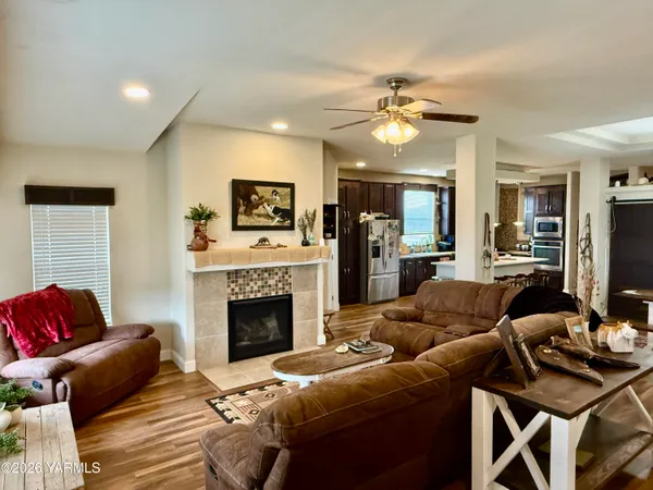 a living room with furniture a fireplace and a flat screen tv