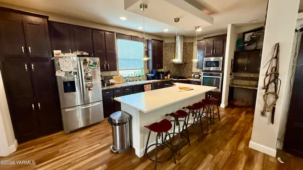 a kitchen with stainless steel appliances a sink stove and refrigerator