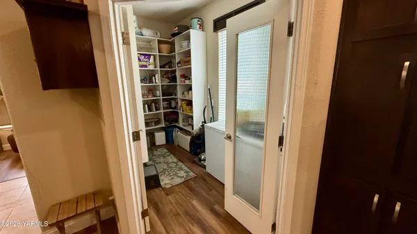 a large kitchen with kitchen island a stove a sink a refrigerator and a dining table with wooden floor