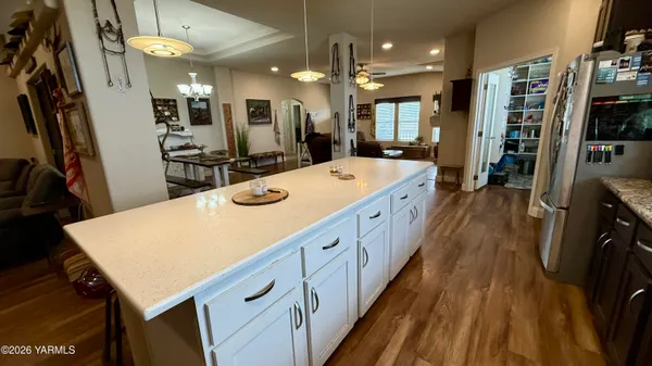 a living room with furniture a flat screen tv and a window