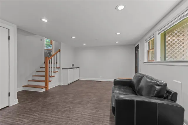 a living room with furniture and stairs