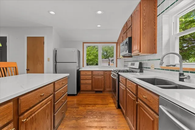 a kitchen with sink a window and cabinets