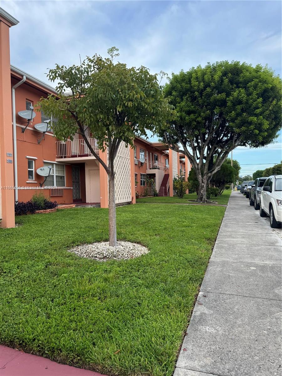 3551 Southwest 10th Street, Unit 8A Miami, FL 33135 - Photo 1 of 10 a front view of house with yard and green space